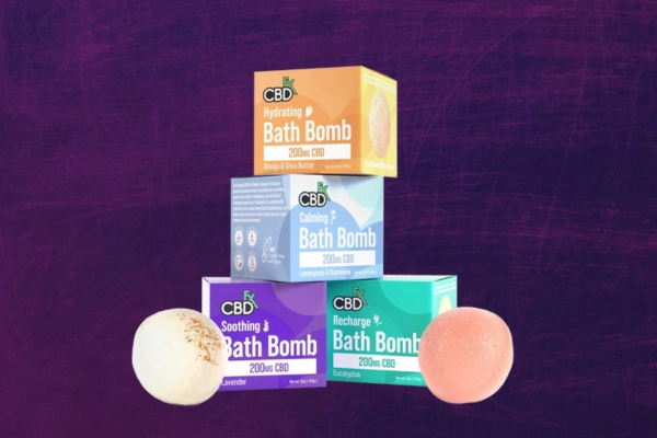 Stack of CBD bath bomb boxes with bath bombs in front