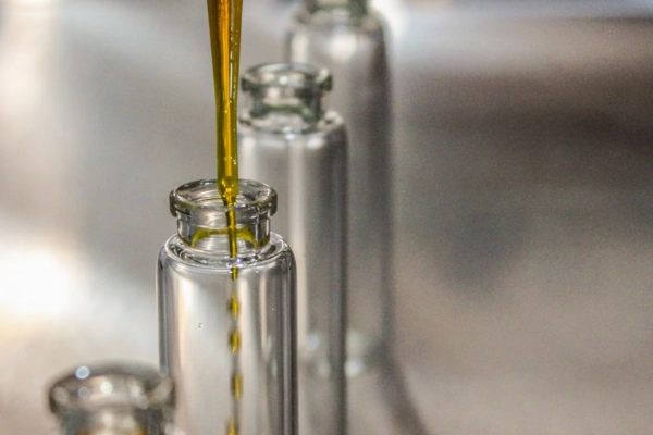 Cannabis extract being filled into glass tincture bottles