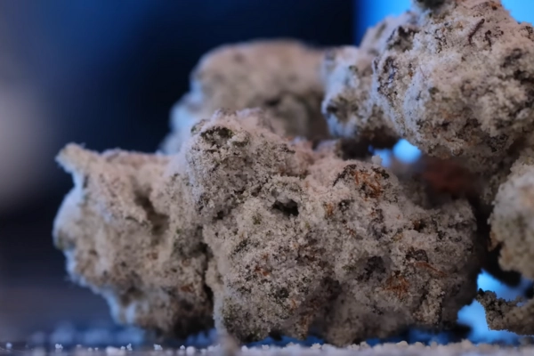 Close-up of frosty snowcapped cannabis buds with THCA coating