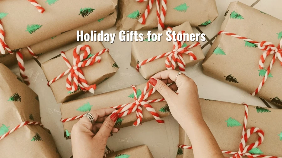Hands tying red-and-white string on holiday presents wrapped in brown paper with small green tree prints and the title “Holiday Gifts for Stoners”