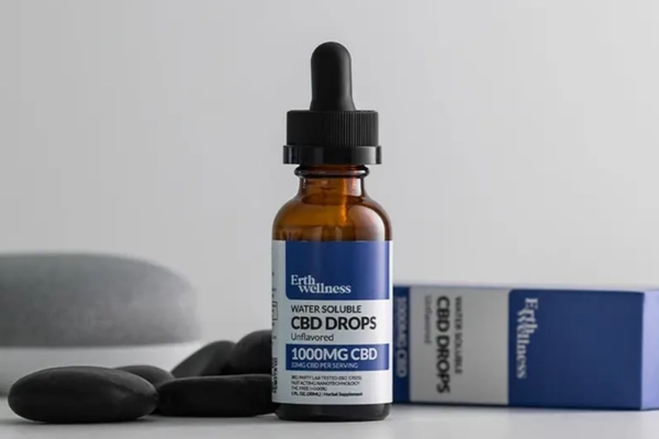 Erth Wellness water-soluble CBD drops bottle with packaging on a neutral background