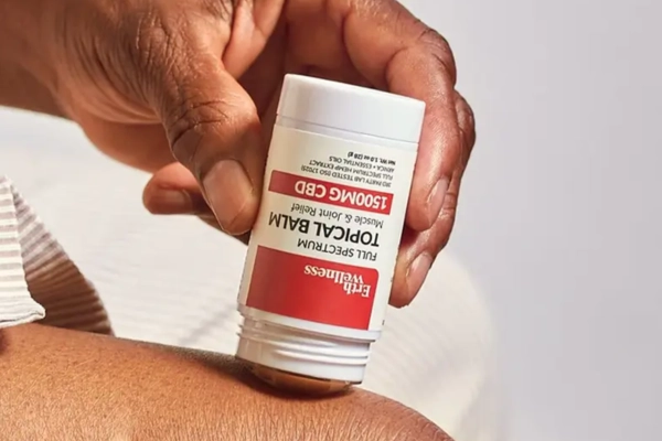 Erth Wellness full-spectrum CBD topical balm stick being applied to skin